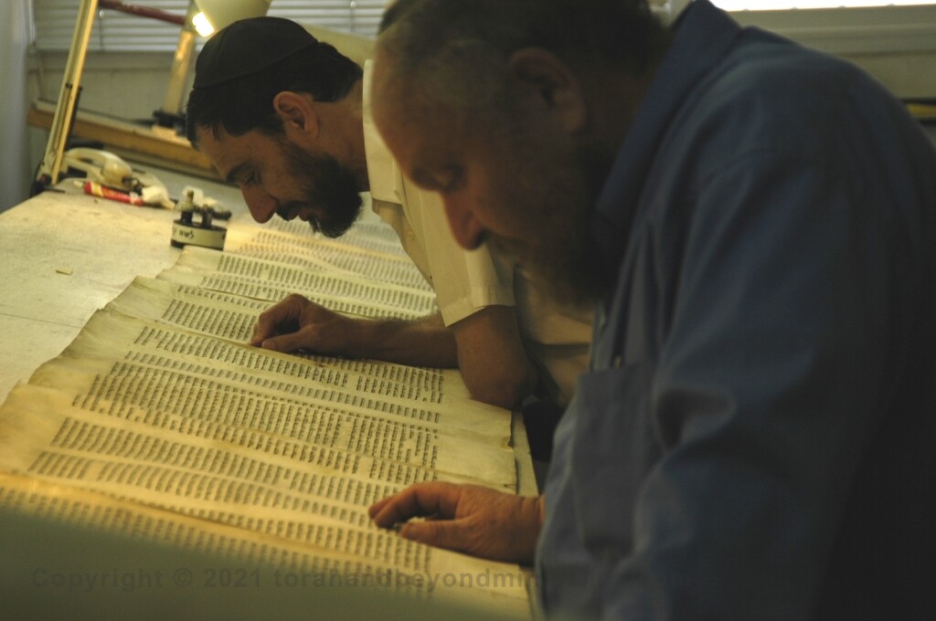 Two Soferim checking a Torah Scroll at Macon OT in Jerusalem 