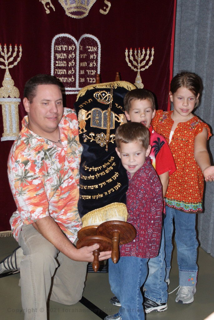 Family holding Torah Scroll at Scroll Seminar in Dallas