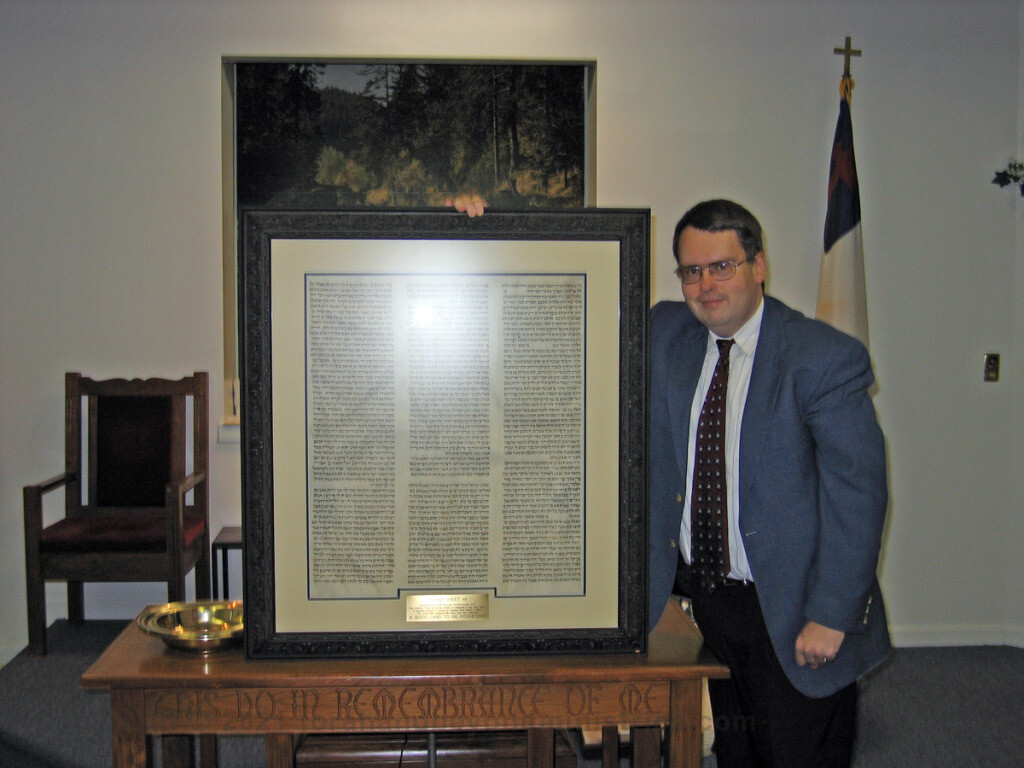 Presenting framed Torah sheet to Baptist church