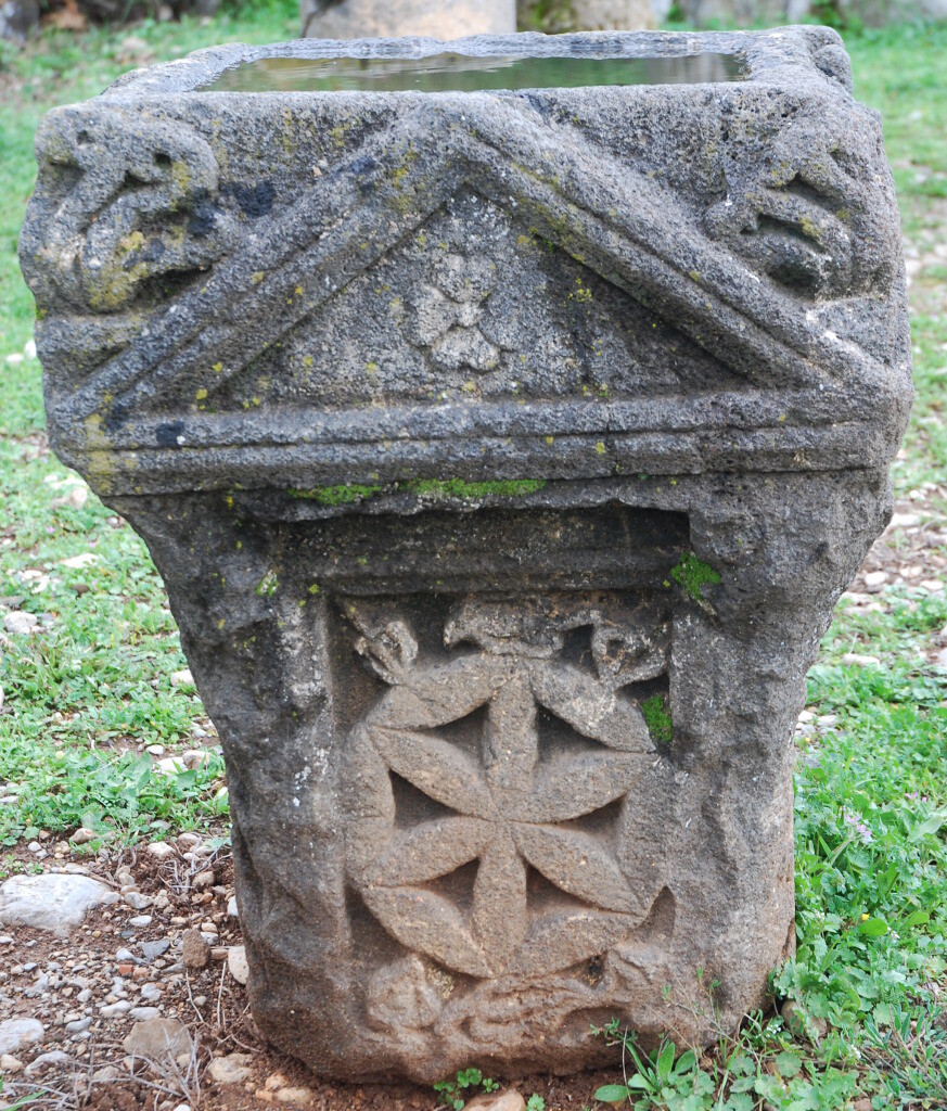 Ancient stone altar shows crocus flower